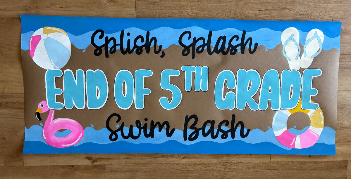 A rectangular printed banner or sign with a beach-themed design reading 'Splash, Splash END OF 5TH GRADE Swim Bash' in black and light blue lettering on a brown background, photographed against a wood floor.
